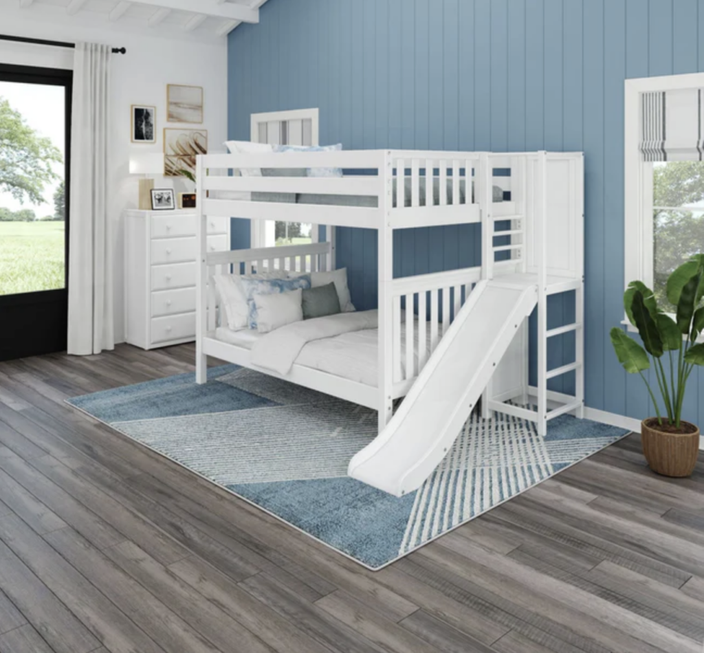 full bunk bed with a slide in a bedroom. 