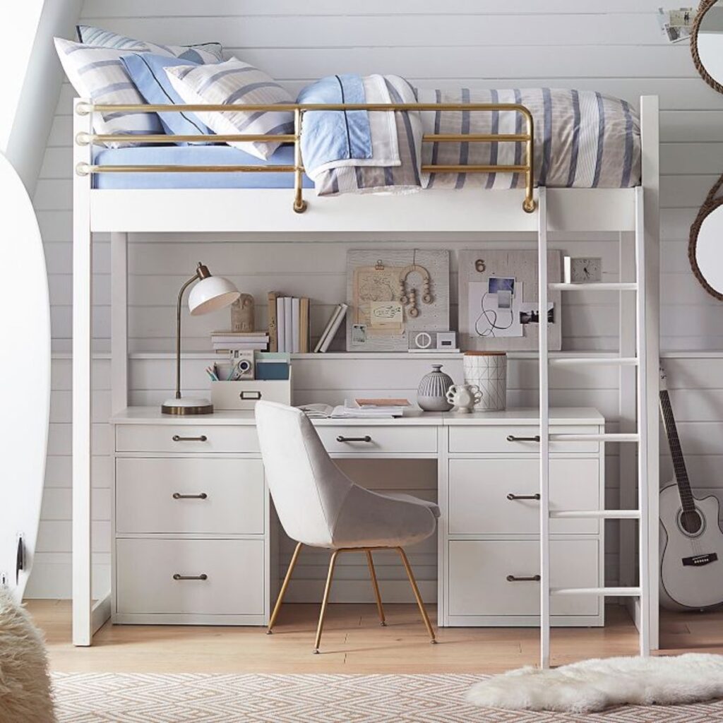 loft bed with gold rail and white desk underneath. 